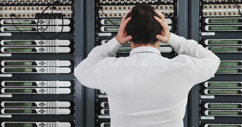 IT professional looking at server wall